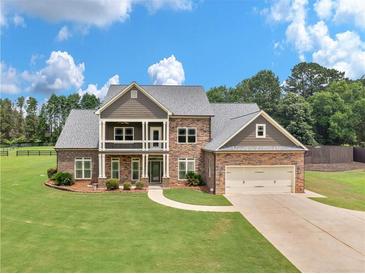 Stunning two-story home with a well-manicured lawn and attached two car garage at 3905 Pointer Rd, Loganville, GA 30052