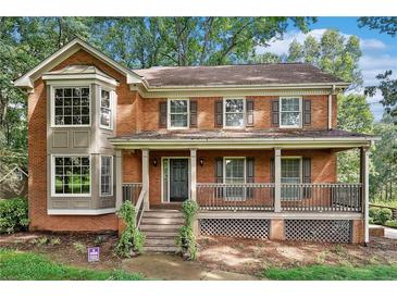 Charming two-story brick home with a welcoming front porch and well-maintained landscaping at 3657 Linda Dr, Loganville, GA 30052