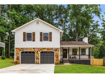 Charming two-story home with a stone-accented garage and a welcoming front porch at 2090 Rocky Mill Drive, Lawrenceville, GA 30044