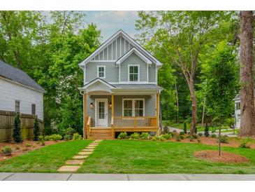 Two-story home with light grey siding, white trim, and a covered porch at 38 Mildred Nw Pl, Atlanta, GA 30318