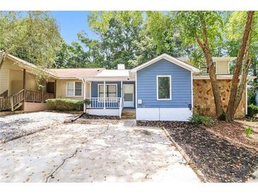 Charming home featuring blue siding, white trim, and a well-manicured front yard at 937 Ohara Drive Dr, Jonesboro, GA 30236