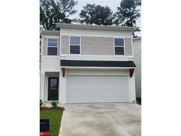 Two-story home with white garage door, neutral siding, and black front door at 4856 Station Road-Lot 21, Union City, GA 30349