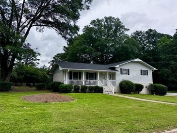 Charming single-Gathering home with a covered front porch and a well-maintained lawn at 3835 Clearwater Dr, Atlanta, GA 30349