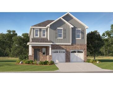 Charming two-story home with brick accents and a well-manicured lawn at 1911 Colestock Se Ave, Conyers, GA 30094