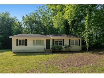 Charming single-story home with black shutters, surrounded by mature trees and a well-maintained lawn at 2802 3Rd Sw Ave, Atlanta, GA 30315