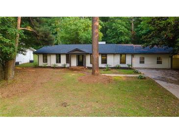 Charming renovated ranch-style home featuring a dark roof, black trim windows, and freshly painted brick at 3790 Village Sw Dr, Atlanta, GA 30331