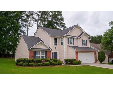 Charming two-story home with well-manicured lawn and brick accents, perfect for suburban living at 1332 Chandler Cove Way, Grayson, GA 30017