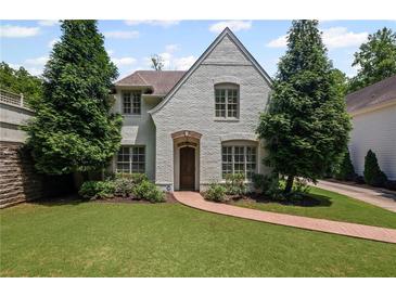 Charming two-story home with a lush lawn and a brick walkway at 2941 Elizabeth Se St, Smyrna, GA 30080