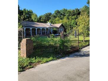 Charming home with wrought iron gate and a large front yard at 435 Johnson Ferry Nw Rd, Atlanta, GA 30328