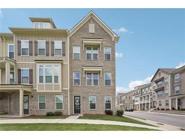 Beautiful three-story townhouse with neutral brick, dark shutters, and well-manicured lawn at 2501 Painted Buckeye Chase Se, Smyrna, GA 30080