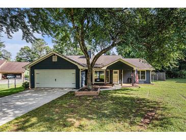 Charming single-Gathering home with a well-manicured lawn and a two-car garage at 50 Blackberry Lane, Covington, GA 30016