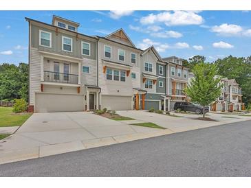 Modern townhome community featuring attached garages, craftsman details, and beautifully landscaped grounds at 3508 Mount Blue Ave, Tucker, GA 30084