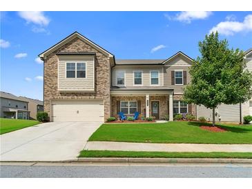 Charming two-story home with a brick and siding exterior, well-manicured lawn, and inviting curb appeal at 850 Ethereow Ct, Lawrenceville, GA 30046