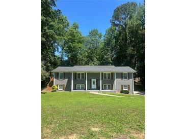 Charming two-story home with gray siding, white trim, shutters, and a well-maintained front yard at 1863 Rockford Ct, Riverdale, GA 30296