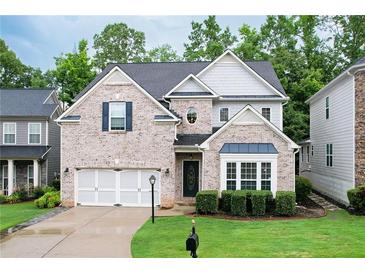 Charming two-story home with brick facade, manicured lawn, and attached two-car garage at 2940 Bentbill Xing, Cumming, GA 30041