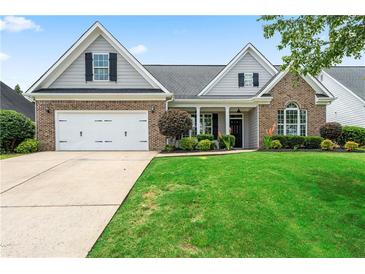 Charming brick home with a well-manicured lawn and inviting curb appeal on a sunny day at 21 Spring Folly Nw, Cartersville, GA 30121