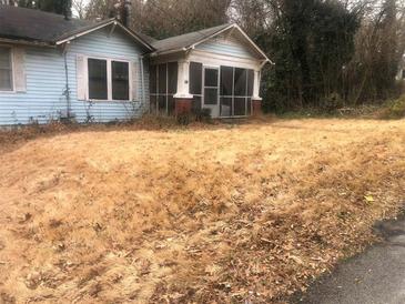 Exterior of light blue home with a covered front porch and large front yard at 702 Emily Pl # 0, Atlanta, GA 30318