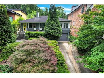 Charming home featuring a well-manicured front yard with beautiful landscaping at 935 Cumberland Ne Rd, Atlanta, GA 30306