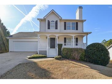 Charming two-story home with a covered front porch, attached garage, and well-maintained landscaping at 341 Windermere Dr., Loganville, GA 30052