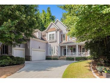 Charming two-story home features a covered porch, two-car garage, and beautifully landscaped front yard at 3698 Lakeview Drive, Tucker, GA 30084