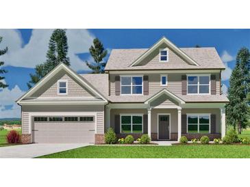 Charming two-story home with a two-car garage, covered porch, and manicured lawn at 1104 Cherry Bark Ln, Loganville, GA 30052