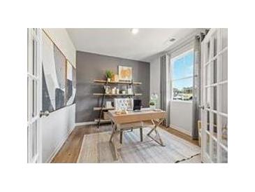 Bright office space with french doors, a neutral color palette, and a large window providing ample natural light at 8505 Poston Place Lot 141, Douglasville, GA 30134
