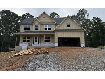 New two-story home featuring a covered porch, an attached two-car garage, and a neutral color palette at 1079 Birch Way Ct, Loganville, GA 30052