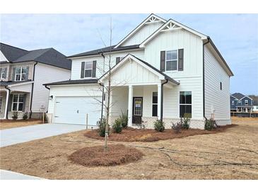 Charming two-story home featuring white siding, a covered entry, and a convenient two-car garage at 2674 Mourning Dove Drive (Lot 37), Grayson, GA 30017