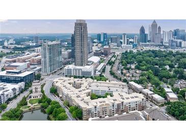 Stunning aerial view of a modern apartment complex surrounded by lush green trees in a bustling urban environment at 390 17Th Nw St # 2053, Atlanta, GA 30363