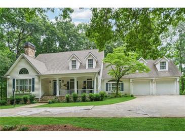 Charming home with a manicured lawn, inviting front porch and an attached three car garage at 34 Johnston Nw Row, Cartersville, GA 30121