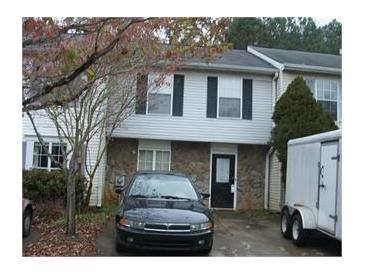 Two story home featuring a stone front, black door and black shutters on the front windows at 3541 Kennesaw Station Nw Dr, Kennesaw, GA 30144