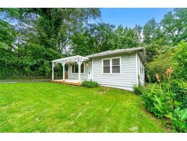 Charming home featuring a welcoming front porch, green lawn, and mature trees creating a serene setting at 1649 Nw Ezra Church Nw Dr, Atlanta, GA 30314