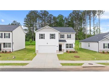 Charming two-story home featuring a two-car garage and beautifully maintained landscaping at 1622 Palladian Way, Lithonia, GA 30058