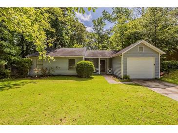 Charming single-story home with a well-maintained lawn, mature trees and an attached single car garage at 6200 Beaver Creek Trl, Atlanta, GA 30349