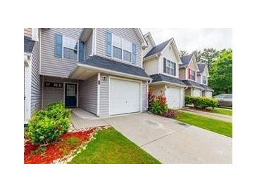 Charming townhouse with a one car garage and landscaped front yard offering curb appeal at 6726 Gallant Se Ct # 30, Mableton, GA 30126