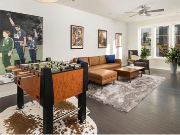 Inviting living room with stylish foosball table, leather sofa, and elegant decor at 415 Gartrell Se St # 16, Atlanta, GA 30312