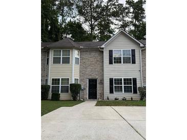 Charming two-story townhome featuring a brick facade, neutral siding, and a well-maintained front lawn at 5538 Pineridge Ct, Forest Park, GA 30297