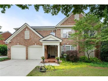 Charming brick home with a well-manicured front yard and a two-car garage in a desirable neighborhood at 2350 Rosebrook Se Xing, Atlanta, GA 30339