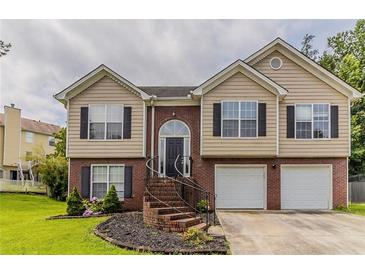 Charming split-level home with a brick facade, well-manicured lawn, and a two-car garage at 1006 Eagle Vw, Lawrenceville, GA 30044