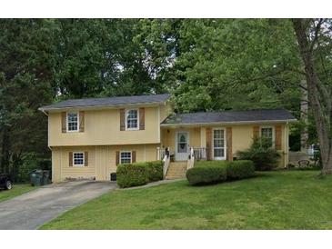 Inviting exterior view of a two-story home, featuring a well-manicured lawn and mature trees at 3025 Butler Creek Nw Rd, Kennesaw, GA 30152