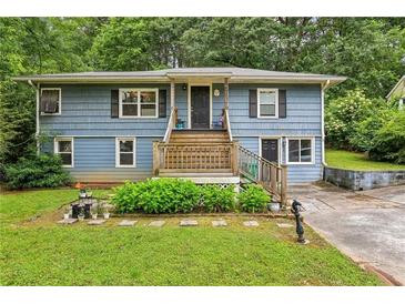 Charming split-level home with blue siding, inviting front porch, and well-maintained landscaping at 428 Medlock Rd, Decatur, GA 30030