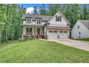 Charming craftsman-style home featuring a welcoming front porch and a well-manicured lawn at 104 Woodland Ln, Canton, GA 30114