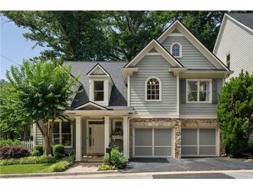 Charming two-story home with a well-manicured lawn and a two-car garage at 1360 Edmund Ne Ct, Atlanta, GA 30306
