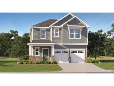 Charming two-story home with gray siding, white trim, double garage, and well-manicured lawn at 1924 Logan Se Ln, Conyers, GA 30094