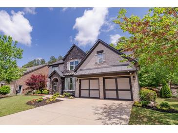 Stunning two-story home with a manicured lawn, beautiful stone accents, and a spacious two-car garage at 2720 Garonne Way, Cumming, GA 30041