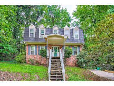 Charming brick home with a welcoming entrance and lush green surroundings at 2867 Holly Oaks Dr, Marietta, GA 30062