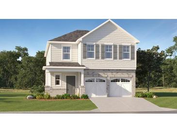 Charming two-story home with white siding, stone accents, and a two-car garage provides great curb appeal at 1817 Holmsey Se Cir, Conyers, GA 30094