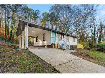 Charming single-story home featuring a covered carport and inviting blue front door at 2903 Akron Street, East Point, GA 30344