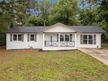 Charming renovated ranch-style home featuring a welcoming front porch and a freshly painted white brick facade at 8535 Hiram Acworth Hwy, Dallas, GA 30157