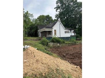 Exterior view of home featuring white siding, a front porch and a well treed yard at 1103 Windsor St, Atlanta, GA 30310